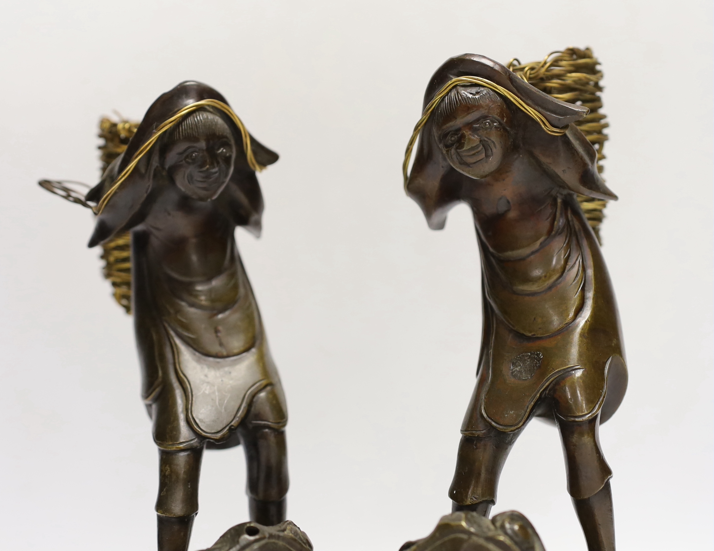 A pair of Japanese bronze boys on a toads, 22cm